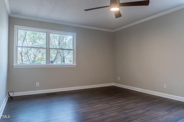 spare room with a textured ceiling, visible vents, dark wood-type flooring, and ornamental molding