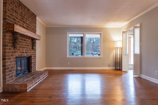 unfurnished living room featuring a textured ceiling, ornamental molding, a brick fireplace, and wood finished floors