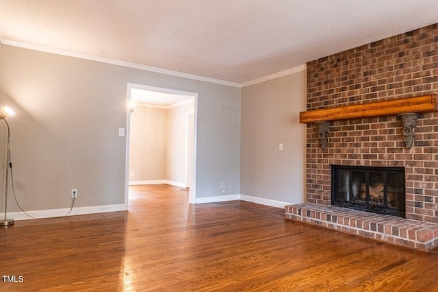 unfurnished living room with baseboards, a fireplace, ornamental molding, and wood finished floors