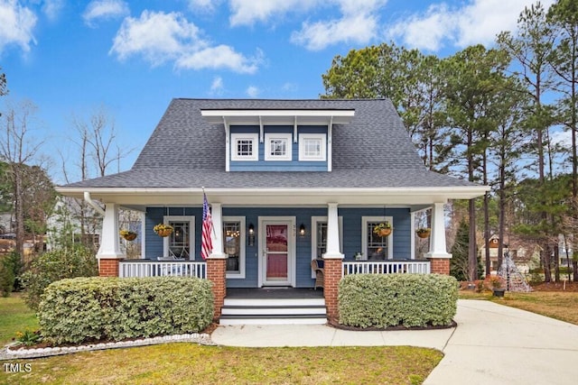 view of front facade with a porch and a shingled roof