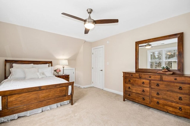 bedroom featuring baseboards, light colored carpet, lofted ceiling, and ceiling fan