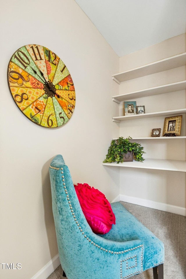 living area with baseboards and carpet floors