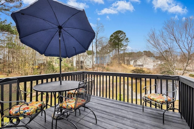 deck featuring outdoor dining space and a residential view