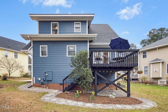 back of property with a deck, stairway, a yard, roof with shingles, and crawl space