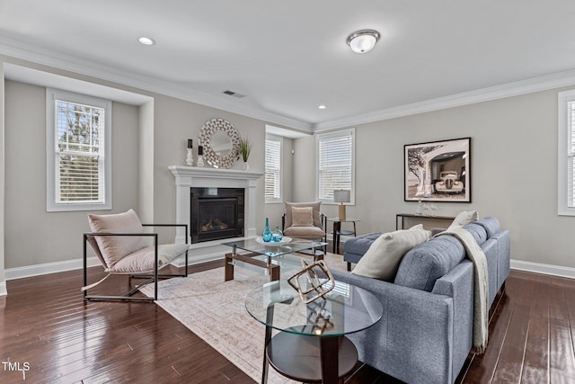 living room with dark wood-style floors, visible vents, baseboards, and ornamental molding