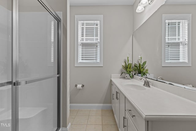 full bathroom with tile patterned floors, baseboards, a shower stall, and vanity