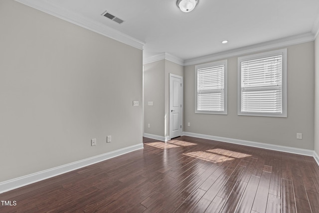 spare room with dark wood finished floors, baseboards, visible vents, and ornamental molding