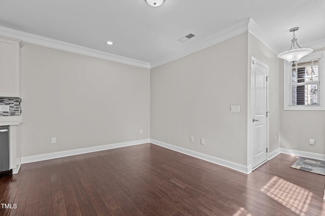 unfurnished living room featuring visible vents, baseboards, dark wood-style floors, and crown molding