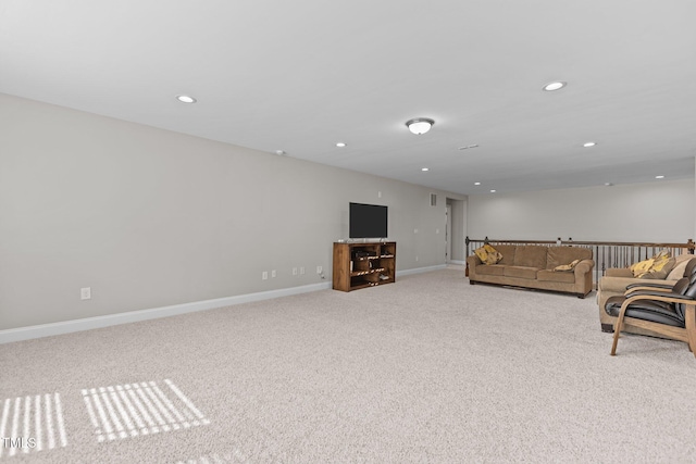 unfurnished living room with carpet flooring, recessed lighting, and baseboards