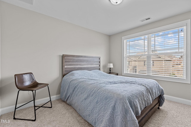 carpeted bedroom with visible vents and baseboards