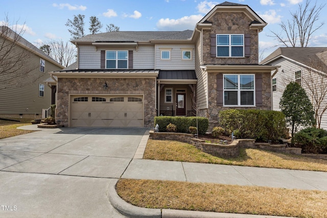 view of front of home with a standing seam roof, a garage, stone siding, and driveway