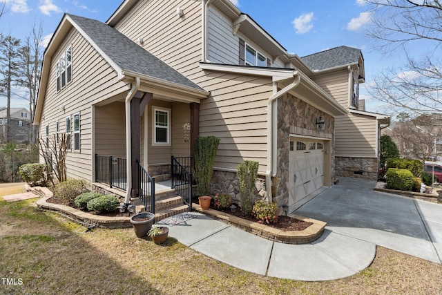 view of side of property featuring stone siding, a garage, concrete driveway, and roof with shingles