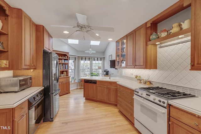 kitchen with white gas range, black oven, stainless steel refrigerator with ice dispenser, and open shelves