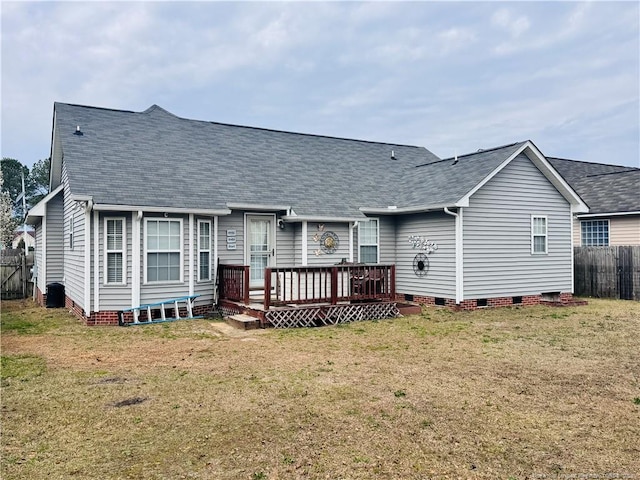 back of property featuring a deck, fence, a yard, crawl space, and roof with shingles