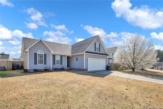 view of front of home featuring central AC unit, driveway, a front yard, and fence