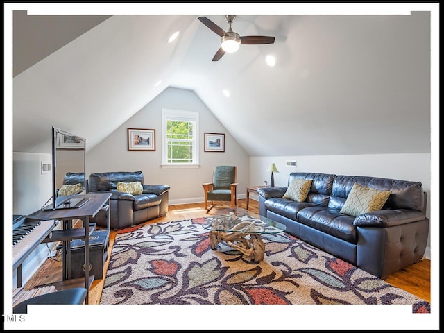 living area with ceiling fan, baseboards, lofted ceiling, and wood finished floors