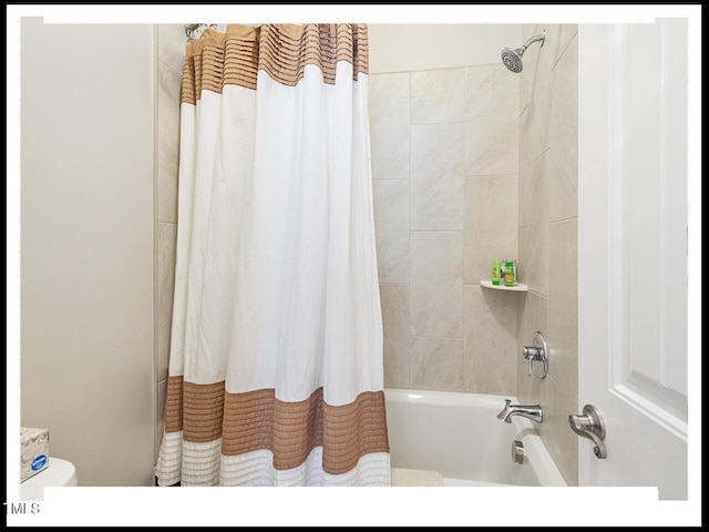 bathroom with toilet and shower / tub combo