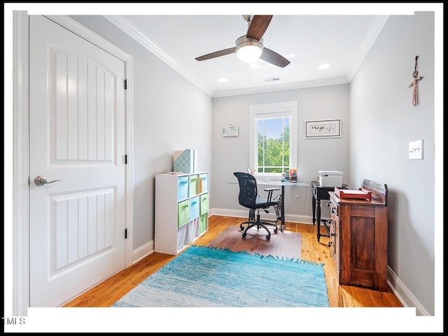 office featuring crown molding, wood finished floors, and baseboards