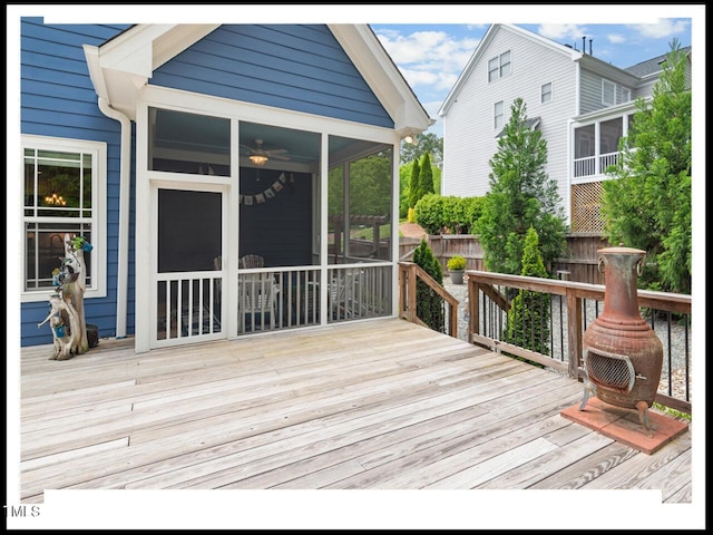 wooden terrace with fence and a sunroom