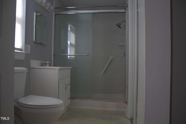 bathroom featuring a shower stall, toilet, and vanity