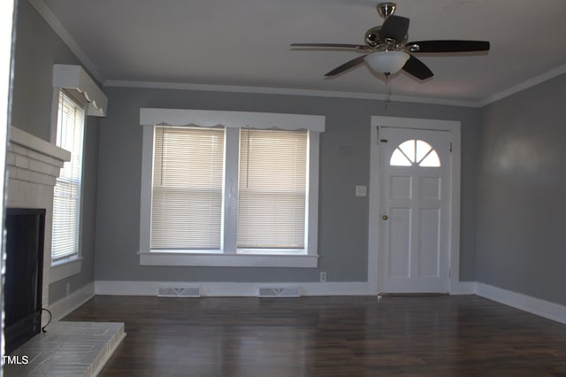 entrance foyer featuring baseboards, wood finished floors, visible vents, and crown molding