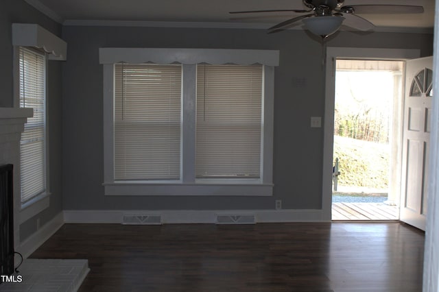 interior space featuring visible vents, crown molding, and wood finished floors