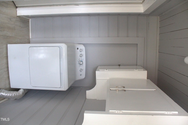 washroom featuring wood walls