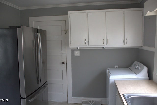 clothes washing area featuring laundry area, a sink, visible vents, ornamental molding, and washer and clothes dryer