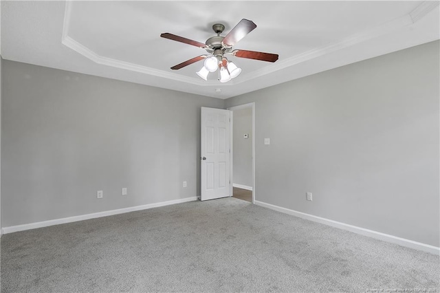empty room featuring ceiling fan, carpet floors, and baseboards