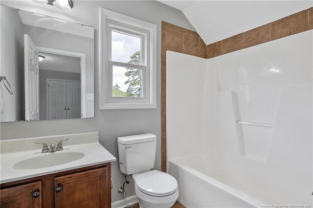 bathroom with lofted ceiling, vanity, and toilet