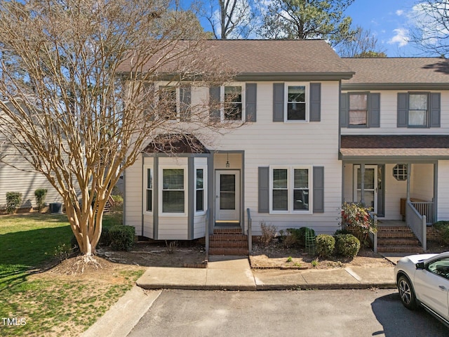 view of front of home featuring covered porch and a shingled roof