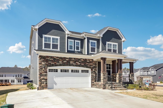 view of front of property featuring concrete driveway, covered porch, a garage, and stone siding