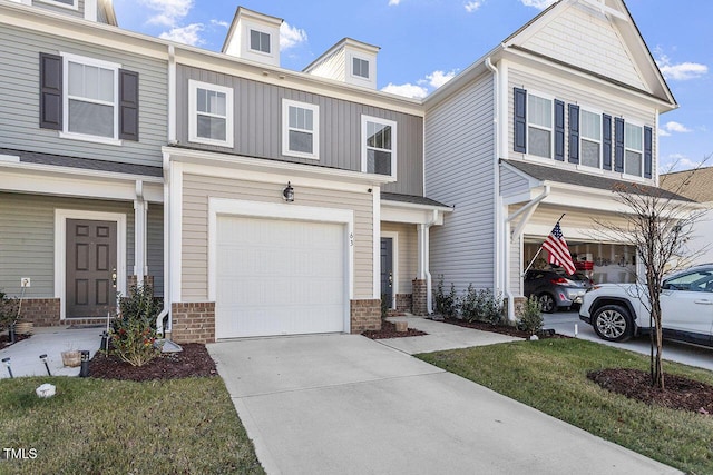 multi unit property with a garage, brick siding, and concrete driveway