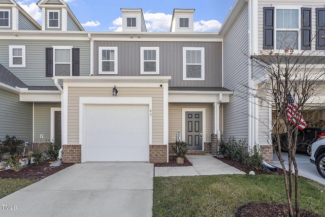 view of property with an attached garage, board and batten siding, and driveway