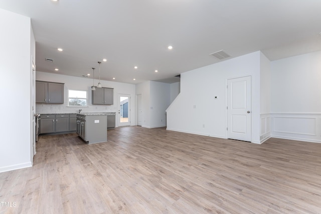 unfurnished living room with light wood-type flooring, visible vents, and recessed lighting