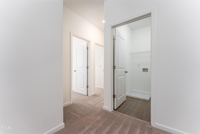 hall featuring carpet floors and baseboards