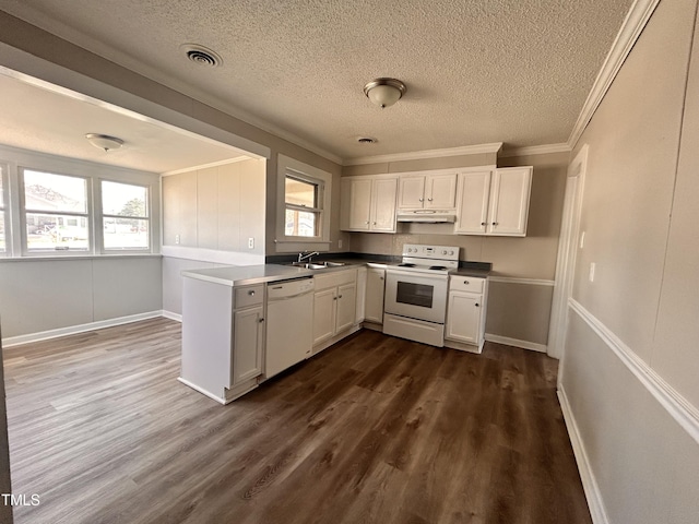 kitchen with under cabinet range hood, white appliances, a sink, white cabinetry, and dark wood-style floors