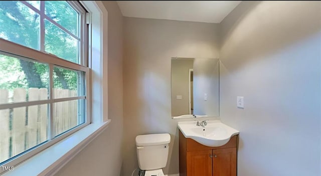 half bathroom with vanity and toilet