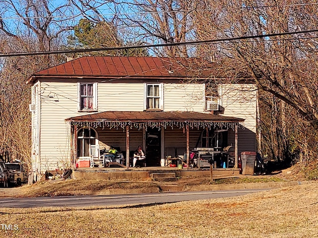 view of front facade with metal roof and a standing seam roof