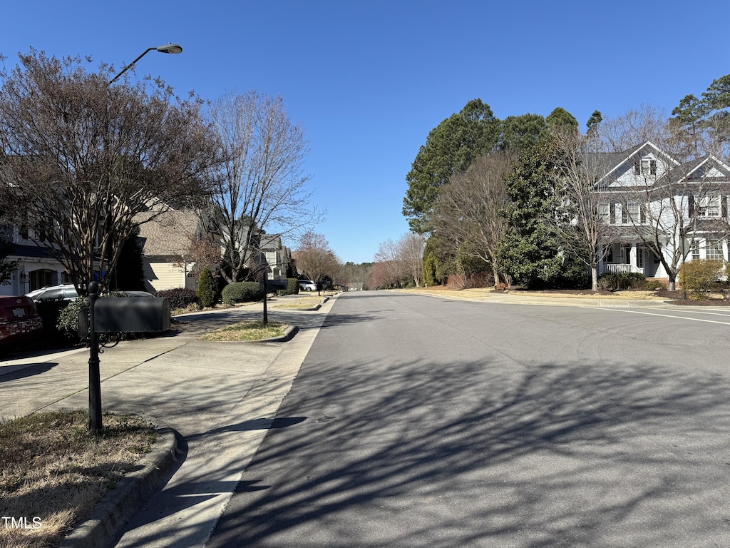 view of road with curbs, street lighting, and sidewalks