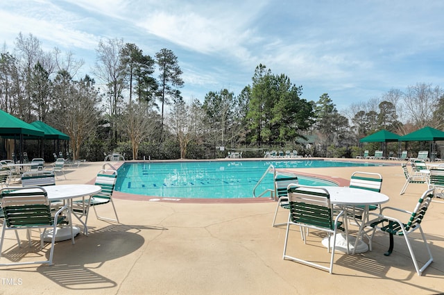 pool with fence and a patio area