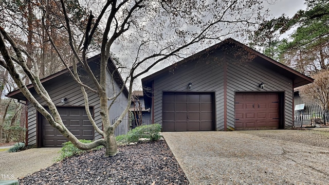 view of front of property featuring a garage and an outdoor structure