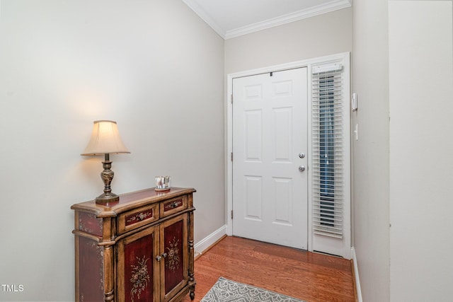 entryway featuring light wood-style floors, baseboards, and ornamental molding