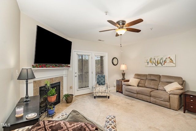 carpeted living room featuring visible vents, ceiling fan, and a fireplace