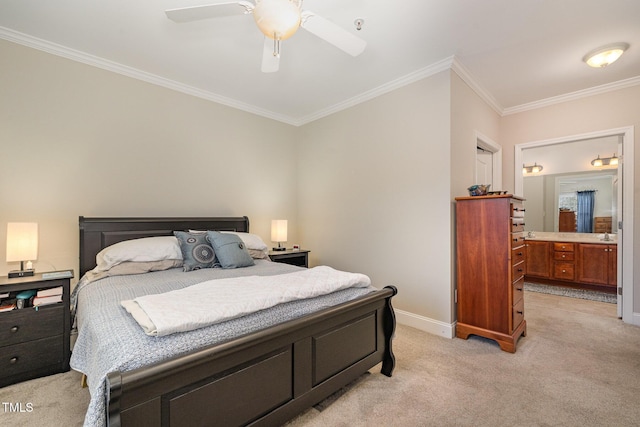 bedroom featuring crown molding, baseboards, light carpet, ensuite bath, and a ceiling fan