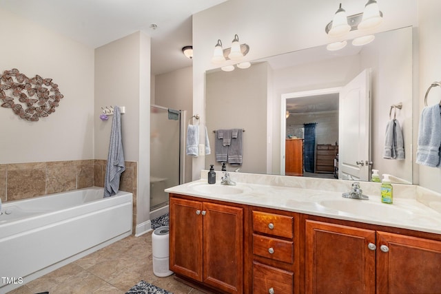 bathroom featuring a bath, a stall shower, and a sink