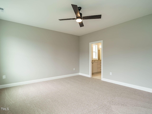 unfurnished room featuring ceiling fan, baseboards, and light colored carpet