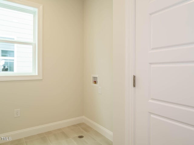 laundry room with hookup for a washing machine, laundry area, and baseboards