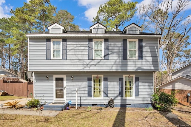 colonial house featuring crawl space, a front yard, and fence