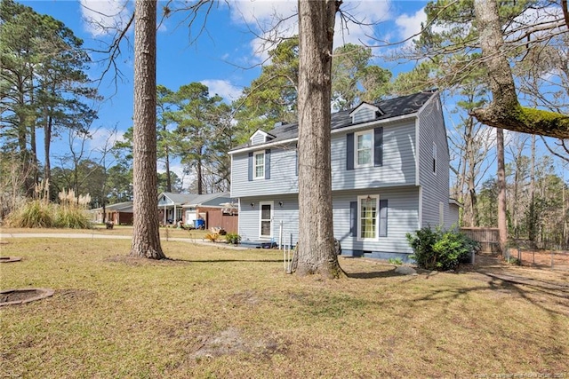 exterior space featuring crawl space, fence, and a front lawn